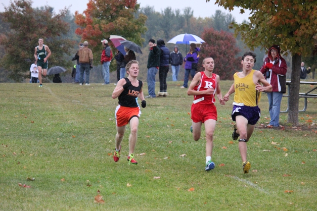 Jon (UXC runner on the left) ran a gutsy race in the rain at the county meet.  He ran the entire race in a pack of 3 runners in the front, fighting for the top spot.